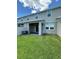 Backyard featuring lush green grass, concrete patio, neutral building, and privacy fence at 11634 Woodleaf Dr, Bradenton, FL 34211