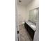 Bathroom with granite countertop vanity, white sink, tiled floor, and combined shower/tub at 11634 Woodleaf Dr, Bradenton, FL 34211