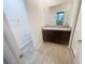 Modern bathroom featuring a double sink vanity, granite countertop, and tiled floors at 11634 Woodleaf Dr, Bradenton, FL 34211