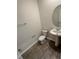The bathroom features a large round mirror and sleek tile flooring at 11634 Woodleaf Dr, Bradenton, FL 34211