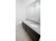 Clean bathroom with a granite countertop, dark cabinets, and tile flooring at 11634 Woodleaf Dr, Bradenton, FL 34211