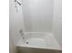 Clean white bathtub with tiled walls and a shower head at 11634 Woodleaf Dr, Bradenton, FL 34211
