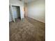 Bedroom featuring plush carpeting, a closet, and soft, neutral-colored walls at 11634 Woodleaf Dr, Bradenton, FL 34211