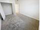 A simple bedroom with carpet and an open closet at 11634 Woodleaf Dr, Bradenton, FL 34211