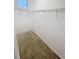 Carpeted walk-in closet with metal shelving, designed to maximize storage and organization at 11634 Woodleaf Dr, Bradenton, FL 34211