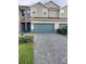 Charming townhome with a paved driveway and two-car garage offering great curb appeal at 11634 Woodleaf Dr, Bradenton, FL 34211