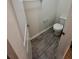 Powder room features tile flooring, a toilet and white walls at 11634 Woodleaf Dr, Bradenton, FL 34211