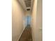 Hallway with neutral paint, carpet flooring, leading to various rooms in the home at 11634 Woodleaf Dr, Bradenton, FL 34211