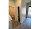 Hallway view highlighting the bathroom and storage room with an open door at 11634 Woodleaf Dr, Bradenton, FL 34211