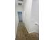 Carpeted hallway leading to different rooms with white walls at 11634 Woodleaf Dr, Bradenton, FL 34211
