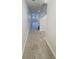 Inviting hallway with tile flooring leading to staircase and additional living spaces at 11634 Woodleaf Dr, Bradenton, FL 34211