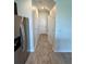 Bright hallway with neutral walls, tile flooring, leading to various rooms in the home at 11634 Woodleaf Dr, Bradenton, FL 34211