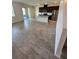 Open concept kitchen with stainless steel appliances, dark cabinetry, and an island with a sink at 11634 Woodleaf Dr, Bradenton, FL 34211