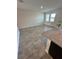 An open living space with a kitchen that includes granite countertops, stainless steel appliances, and tiled flooring at 11634 Woodleaf Dr, Bradenton, FL 34211