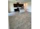 Open concept kitchen with dark cabinets, granite countertops, stainless appliances, and large tile flooring at 11634 Woodleaf Dr, Bradenton, FL 34211