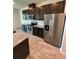 Kitchen with stainless steel appliances, granite countertops and dark cabinetry in a modern home at 11634 Woodleaf Dr, Bradenton, FL 34211