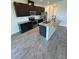 Well-designed kitchen features dark wood cabinets, stainless appliances, tile backsplash, and a functional center island at 11634 Woodleaf Dr, Bradenton, FL 34211