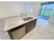 Modern kitchen island featuring granite countertops, stainless steel dishwasher, and a beautiful lake view at 11634 Woodleaf Dr, Bradenton, FL 34211