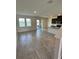 Open-concept living area featuring tile floors, water views, and sleek kitchen at 11634 Woodleaf Dr, Bradenton, FL 34211