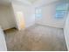 Light filled main bedroom featuring a walk in closet, carpet and abundant windows at 11634 Woodleaf Dr, Bradenton, FL 34211