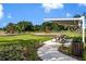 Community playground with picnic tables, ideal for Gathering fun and outdoor activities in a safe and accessible setting at 11634 Woodleaf Dr, Bradenton, FL 34211