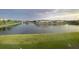 Scenic view of a tranquil pond surrounded by well-maintained landscaping and residential buildings at 11634 Woodleaf Dr, Bradenton, FL 34211
