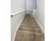 Carpeted stairway leading upstairs, featuring white walls and a handrail at 11634 Woodleaf Dr, Bradenton, FL 34211