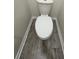 Toilet with modern neutral color, trim and grey flooring at 11634 Woodleaf Dr, Bradenton, FL 34211