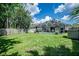 Spacious backyard featuring a pool, screened lanai, and privacy fence at 11837 Derbyshire Dr, Tampa, FL 33626