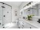 Updated bathroom with glass shower, double sink vanity, and modern lighting at 11837 Derbyshire Dr, Tampa, FL 33626