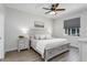 This spacious bedroom features hardwood floors, a ceiling fan, and bright windows at 11837 Derbyshire Dr, Tampa, FL 33626