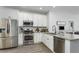 Modern kitchen featuring white cabinets, stainless steel appliances, granite countertops, and sleek fixtures at 11837 Derbyshire Dr, Tampa, FL 33626