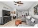 A well-decorated open living space includes a sectional sofa, entertainment center, and bar seating at 11837 Derbyshire Dr, Tampa, FL 33626
