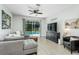 Stylish living room featuring a comfortable sofa, ceiling fan, entertainment center and sliding glass door at 11837 Derbyshire Dr, Tampa, FL 33626