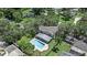 An aerial view shows the home with a backyard pool, surrounded by mature trees in a suburban setting at 1310 Rustlewood Dr, Brandon, FL 33510