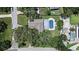 An aerial view showcases the home with a pool and lush greenery in a suburban setting at 1310 Rustlewood Dr, Brandon, FL 33510