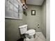 Half bathroom featuring a toilet, window, and tile floors at 1310 Rustlewood Dr, Brandon, FL 33510