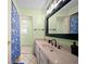 Bright bathroom with neutral tiling, vanity, ample counter space and tub with curtain at 1310 Rustlewood Dr, Brandon, FL 33510