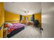 Bedroom with yellow walls, carpet flooring, ceiling fan, and two windows at 1310 Rustlewood Dr, Brandon, FL 33510