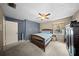 Bedroom featuring blue accent wall, neutral walls, carpet flooring, and window at 1310 Rustlewood Dr, Brandon, FL 33510