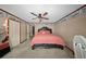 Comfortable bedroom featuring a ceiling fan, plush carpet, and two closets for ample storage space at 1310 Rustlewood Dr, Brandon, FL 33510