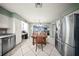 Open dining area with tile flooring, wooden table, stainless steel appliances and light green walls at 1310 Rustlewood Dr, Brandon, FL 33510