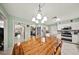 Bright dining area with view into kitchen, featuring a wooden table and decorative chandelier at 1310 Rustlewood Dr, Brandon, FL 33510