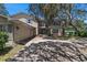 A charming two-story home features a balcony, attached garage, and shade trees in the front yard at 1310 Rustlewood Dr, Brandon, FL 33510