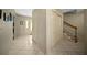 Hallway featuring tile floors, closet storage, and a staircase with wood railing at 1310 Rustlewood Dr, Brandon, FL 33510