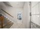 Hallway featuring carpeted stairs, tile floors, and access to a living room at 1310 Rustlewood Dr, Brandon, FL 33510