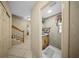 Hallway featuring tile floors, access to a half bathroom, and a staircase with wood railing at 1310 Rustlewood Dr, Brandon, FL 33510