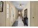 Inviting hallway features tile floors, a decorative table, and interesting oval glass detailing on the front doors at 1310 Rustlewood Dr, Brandon, FL 33510