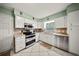 Well-lit kitchen featuring white cabinets, stainless steel appliances and tile flooring at 1310 Rustlewood Dr, Brandon, FL 33510