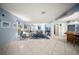 Spacious living room with tile floors, light blue walls, and casual coastal decor at 1310 Rustlewood Dr, Brandon, FL 33510